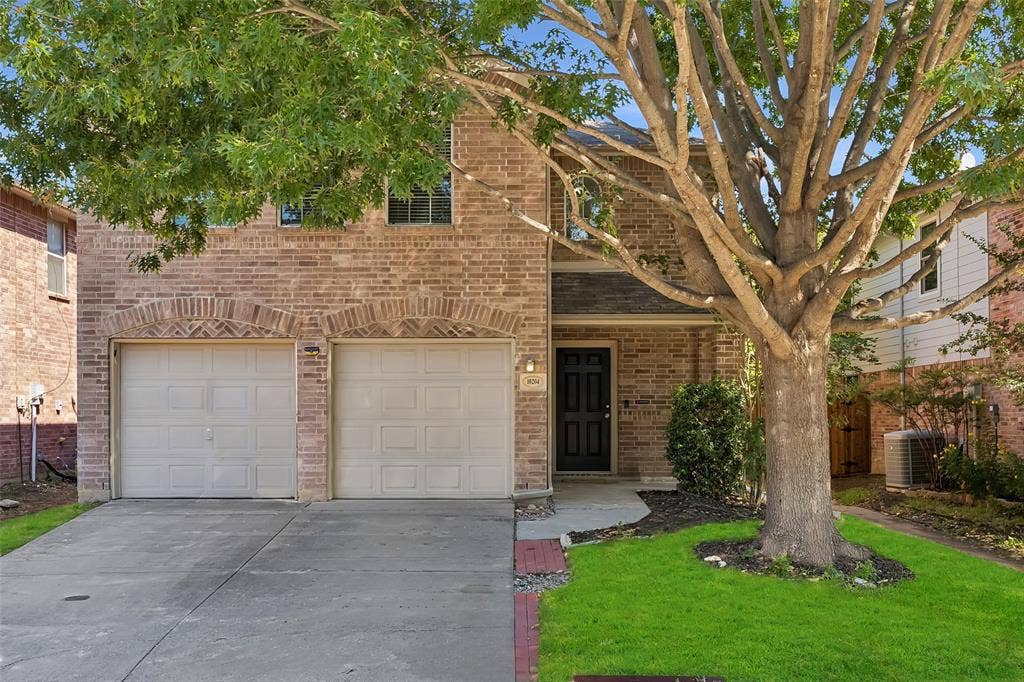 Brick facade with arched garage door openings