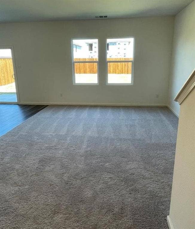 1903 Marquette Drive, Princeton, TX 75407 Plush gray carpeting, white walls, two windows, and a sliding glass door