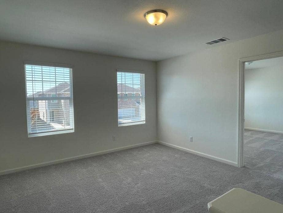 1903 Marquette Drive, Princeton, TX 75407 Bright interior with neutral carpeting and a semi-flush mount ceiling fixture