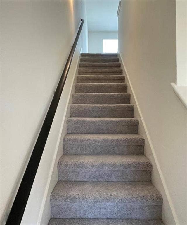 1903 Marquette Drive, Princeton, TX 75407 Carpeted staircase with a dark-finished handrail and light-toned walls