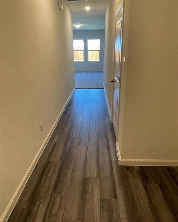 1903 Marquette Drive, Princeton, TX 75407 Hallway featuring wood-finish flooring, light neutral wall tones, and white trim
