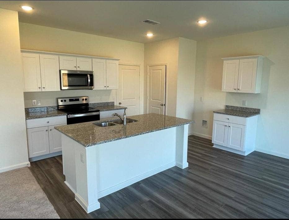 1903 Marquette Drive, Princeton, TX 75407 Kitchen featuring white cabinetry, stainless steel appliances, granite countertops, and wood-finish flooring