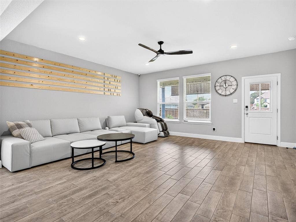 2504 Wren Lane, Denton, TX 76205 Wood-finish flooring, recessed lighting, ceiling fan, and multiple windows with blinds
