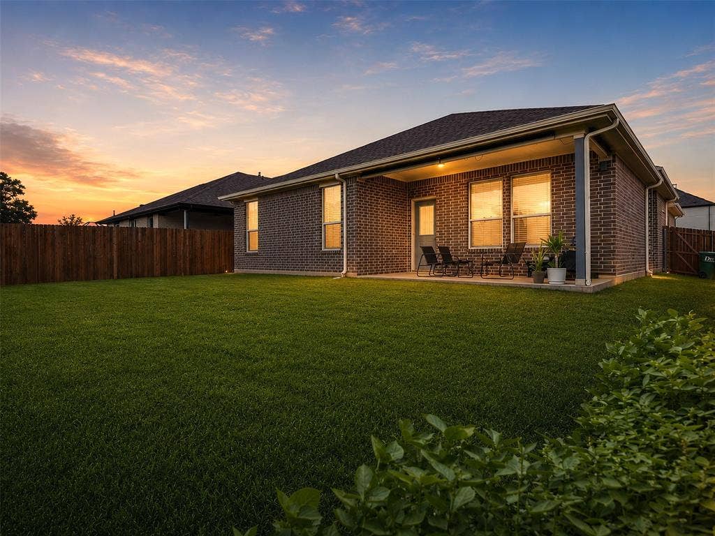 2504 Wren Lane, Denton, TX 76205 Expansive lawn with a wooden privacy fence and mature landscaping