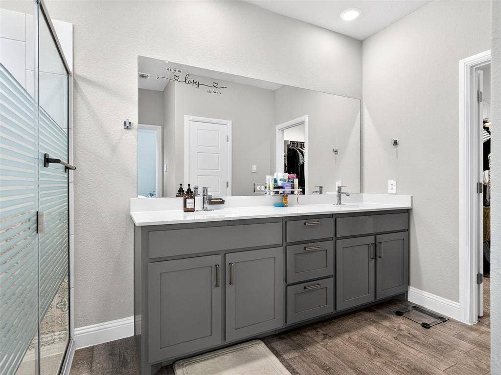 2504 Wren Lane, Denton, TX 76205 Dual vanity with grey cabinetry, white countertops, and integrated sinks