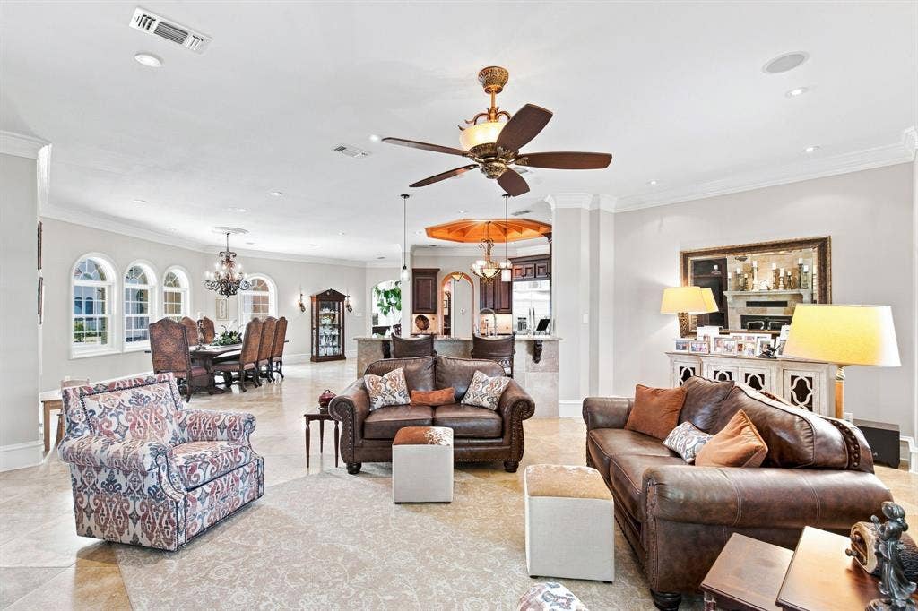 Open-concept living area with tile flooring, recessed lighting, and a ceiling fan