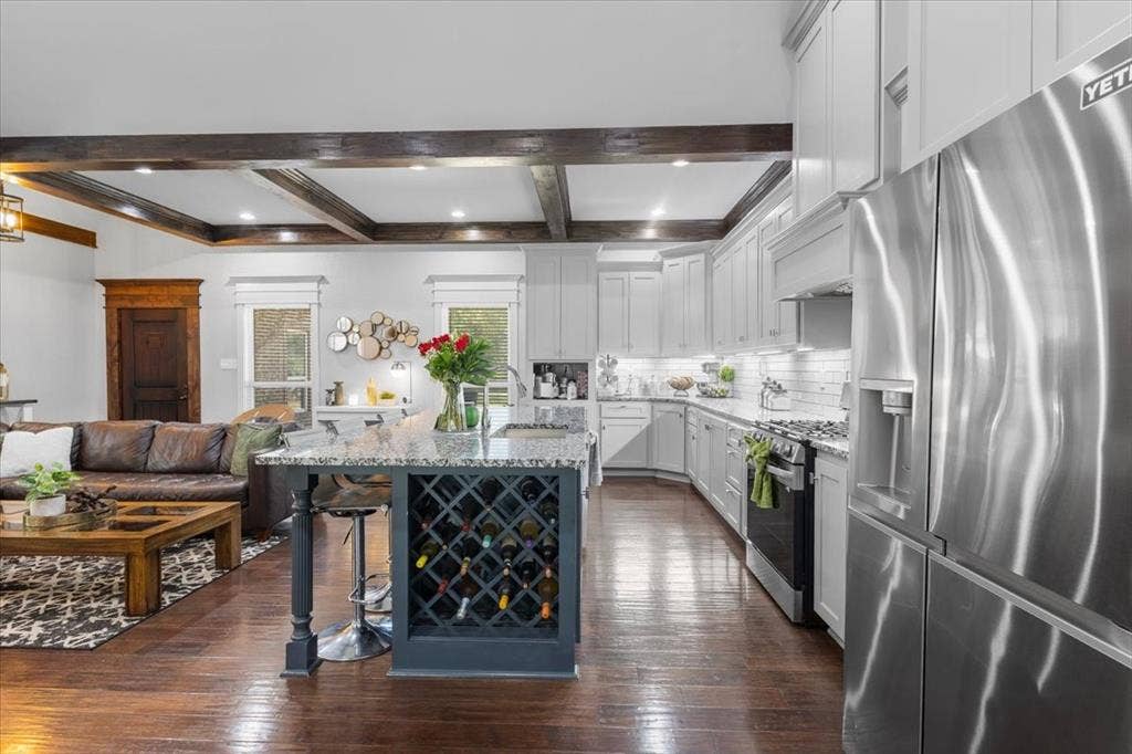 16136 County Road 1134=, Tyler, TX 75709 Hardwood-finish flooring, coffered ceiling with recessed lighting, kitchen island with built-in wine storage, stainless steel refrigerator, and white cabinetry