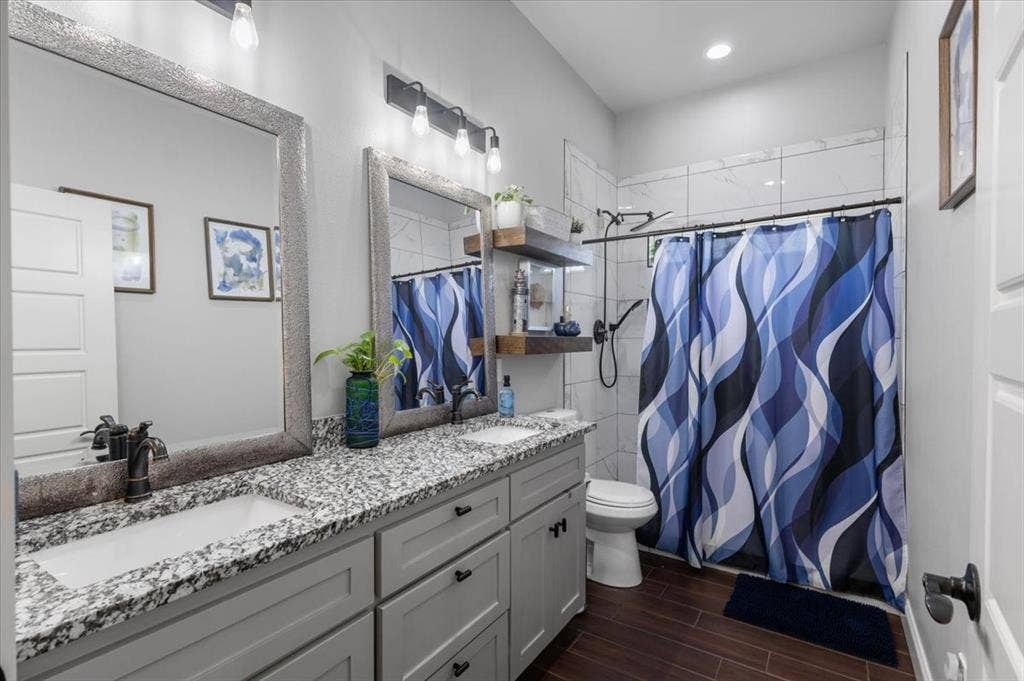 16136 County Road 1134=, Tyler, TX 75709 Double vanity with granite-style countertop, dual rectangular undermount sinks, and dark bronze-finish fixtures