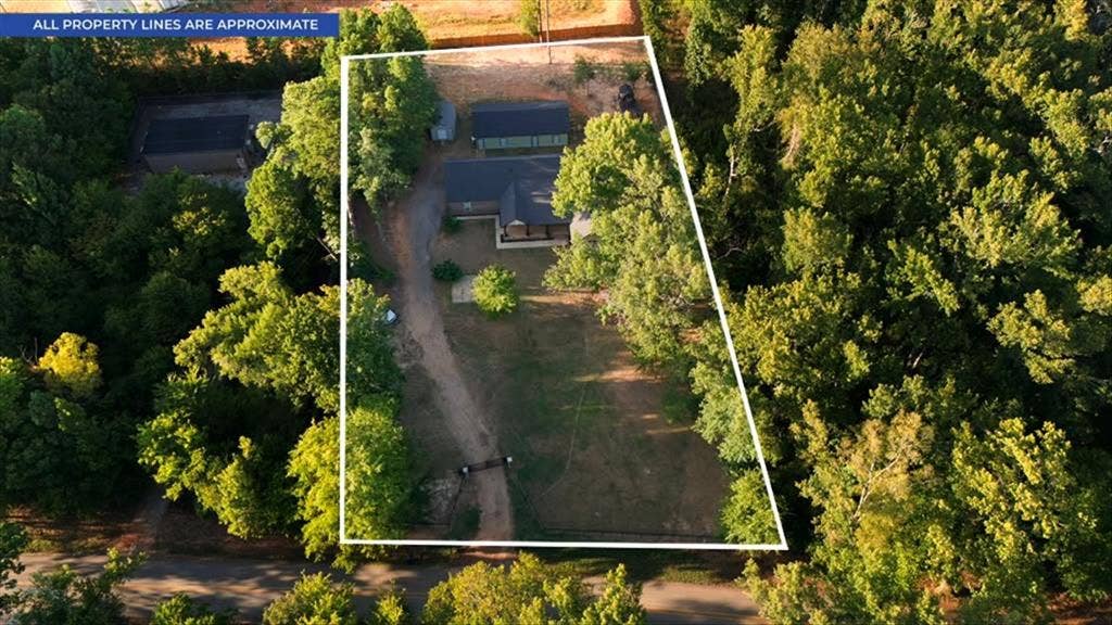 16136 County Road 1134=, Tyler, TX 75709 Expansive property featuring a main residence, secondary structure, and surrounding mature trees