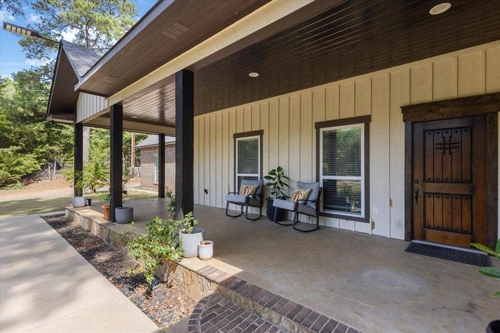16136 County Road 1134=, Tyler, TX 75709 Expansive covered porch with dark wood columns and recessed lighting