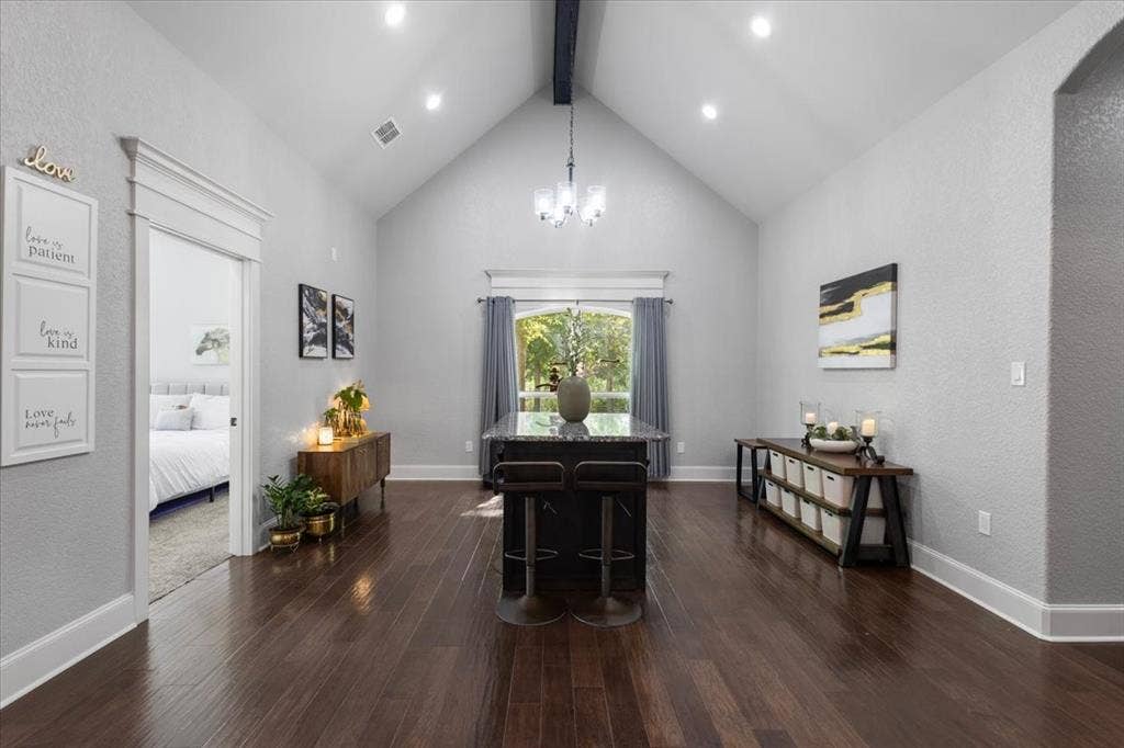 16136 County Road 1134=, Tyler, TX 75709 Vaulted ceiling with an exposed beam, recessed lighting, wood-finish flooring, and a kitchen island with seating