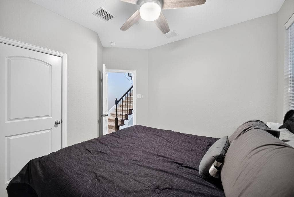 7880 Oxer Drive, Irving, TX 75063 White walls, white arched-panel door, and a ceiling fan with light fixture