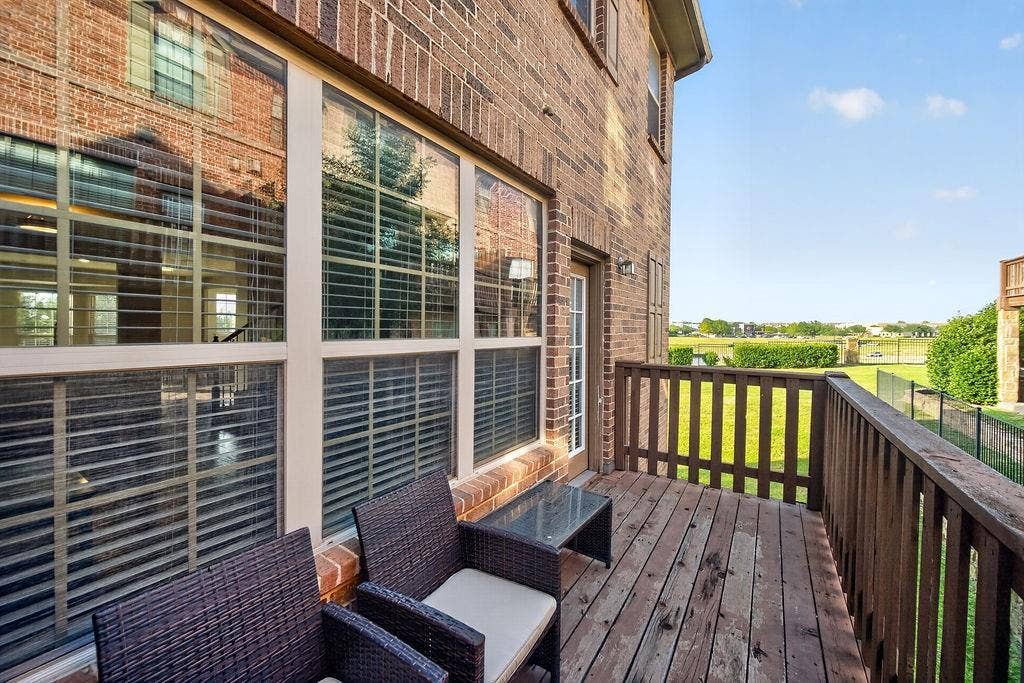 7880 Oxer Drive, Irving, TX 75063 Outdoor deck with wood-finish flooring, wood railing, and brick exterior