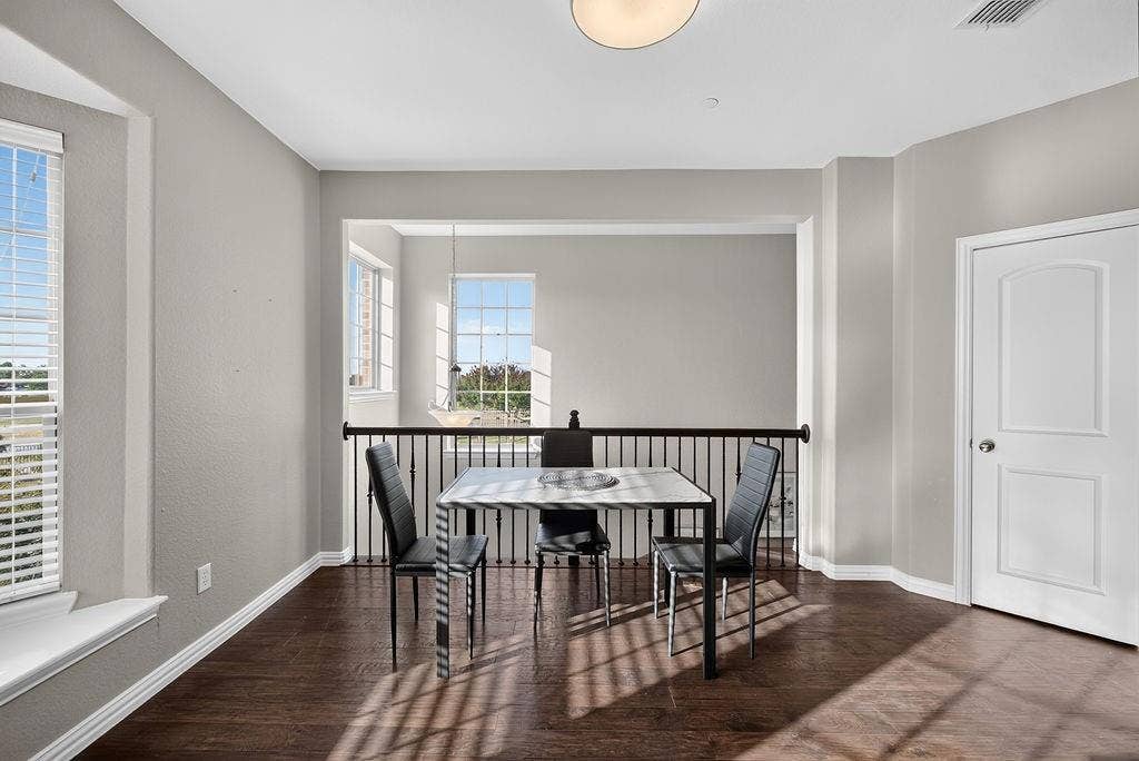 7880 Oxer Drive, Irving, TX 75063 Open concept interior featuring wood-finish flooring, a contemporary ceiling light fixture, and white interior doors