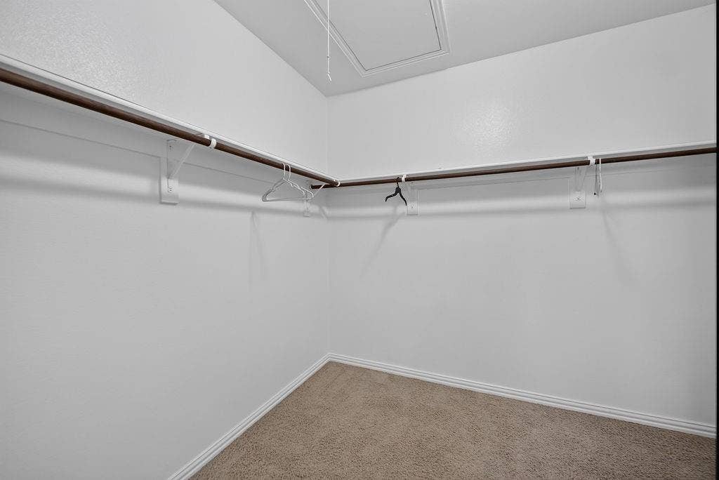 7880 Oxer Drive, Irving, TX 75063 Carpeted closet with a built-in hanging rod system and white walls