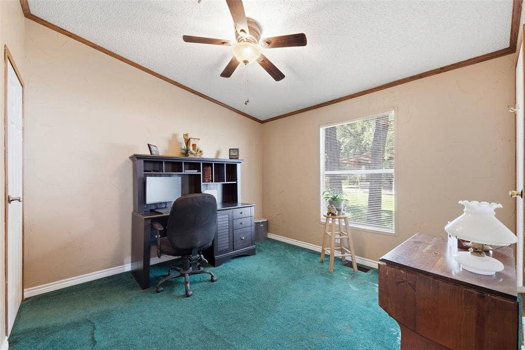 18404 Pine Drive, Eustace, TX 75124 Vaulted ceiling with a ceiling fan, window with horizontal blinds, neutral wall paint, and wood-finish trim