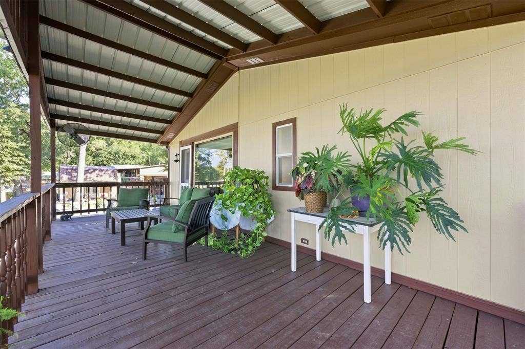 18404 Pine Drive, Eustace, TX 75124 Expansive covered deck featuring wood-finish flooring, a metal roof, and a wood railing