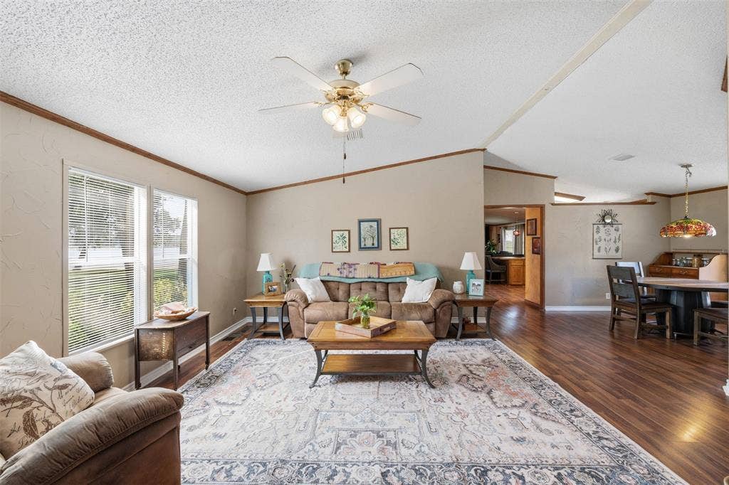 18404 Pine Drive, Eustace, TX 75124 Spacious living area featuring wood-finish flooring, two large windows, and a ceiling fan