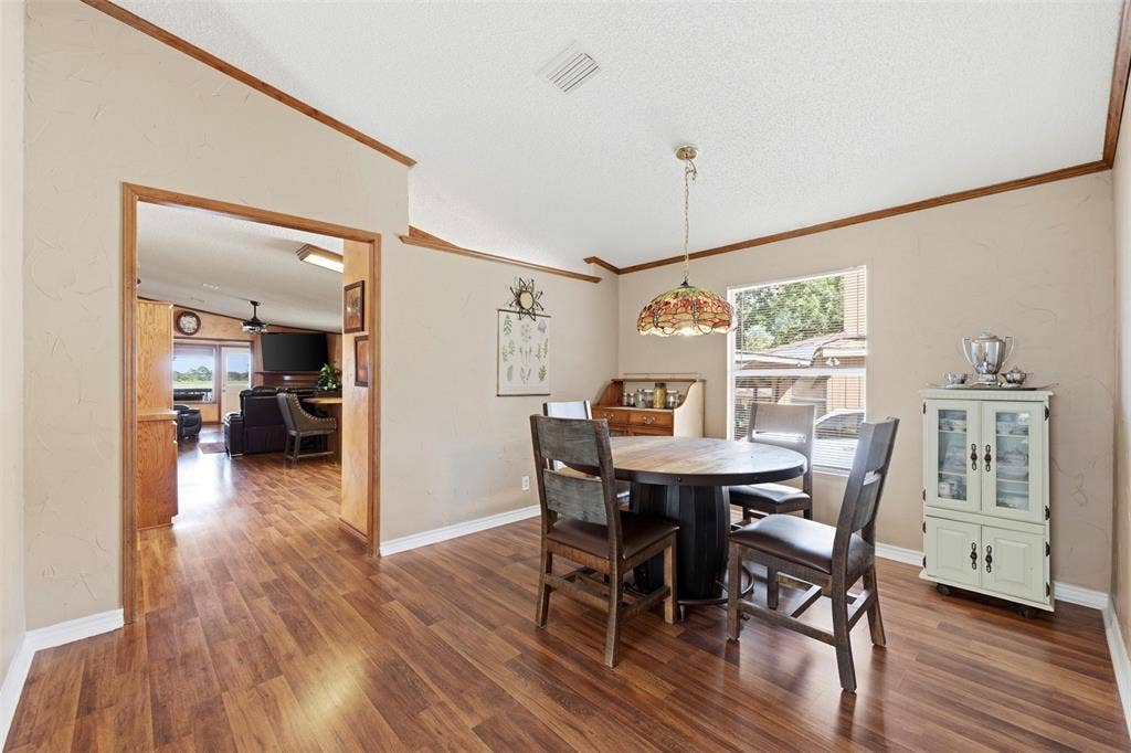18404 Pine Drive, Eustace, TX 75124 Wood-finish flooring throughout, light-colored walls, wood trim accents, and a window providing natural light