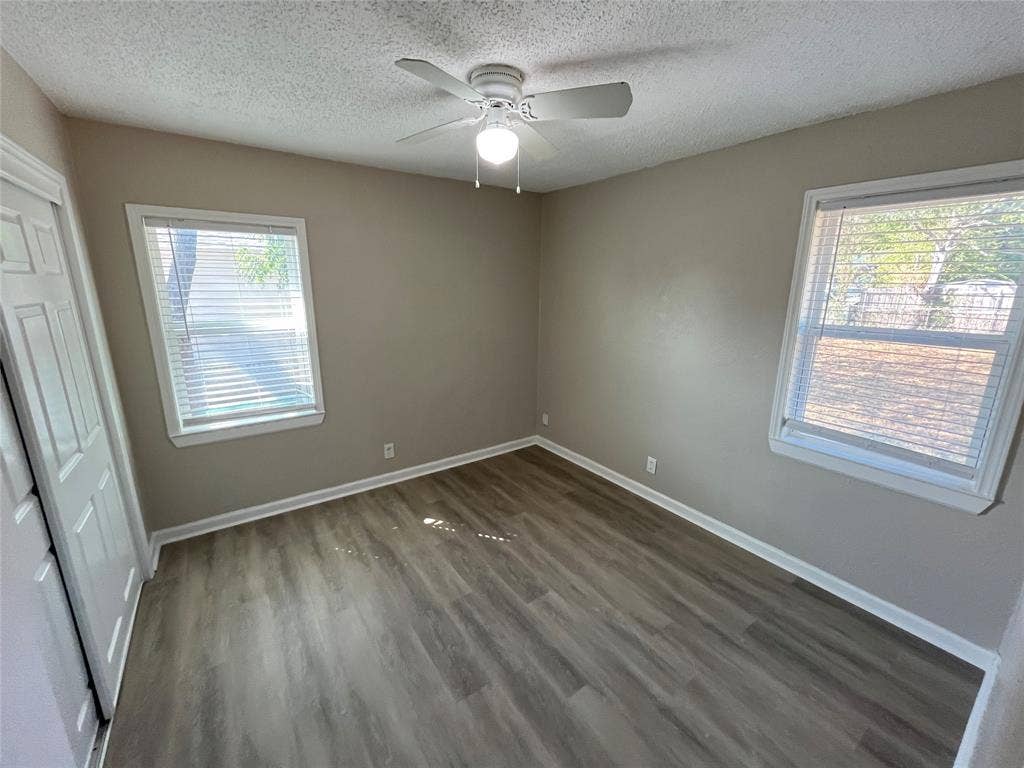 427 NE 38th Street, Grand Prairie, TX 75050 Wood-finish flooring with white trim and neutral wall tones