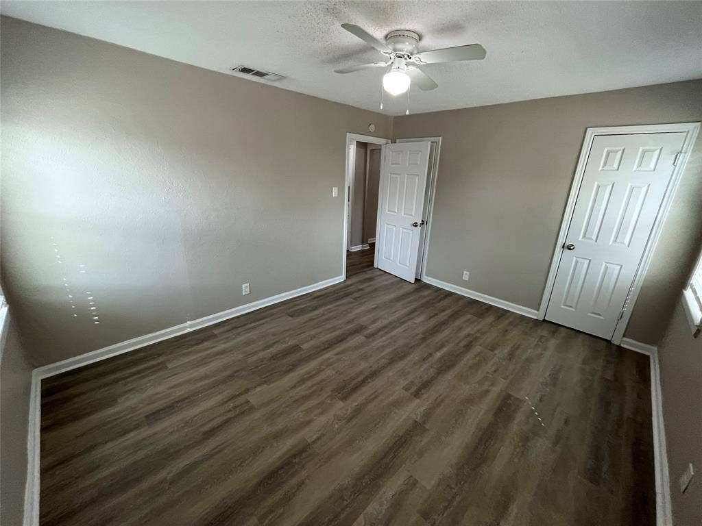 427 NE 38th Street, Grand Prairie, TX 75050 Wood-finish flooring with white trim, a ceiling fan with integrated lighting, and neutral wall tones