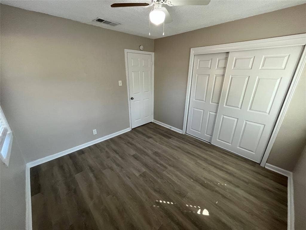 427 NE 38th Street, Grand Prairie, TX 75050 Wood-finish flooring, ceiling fan, and sliding closet doors