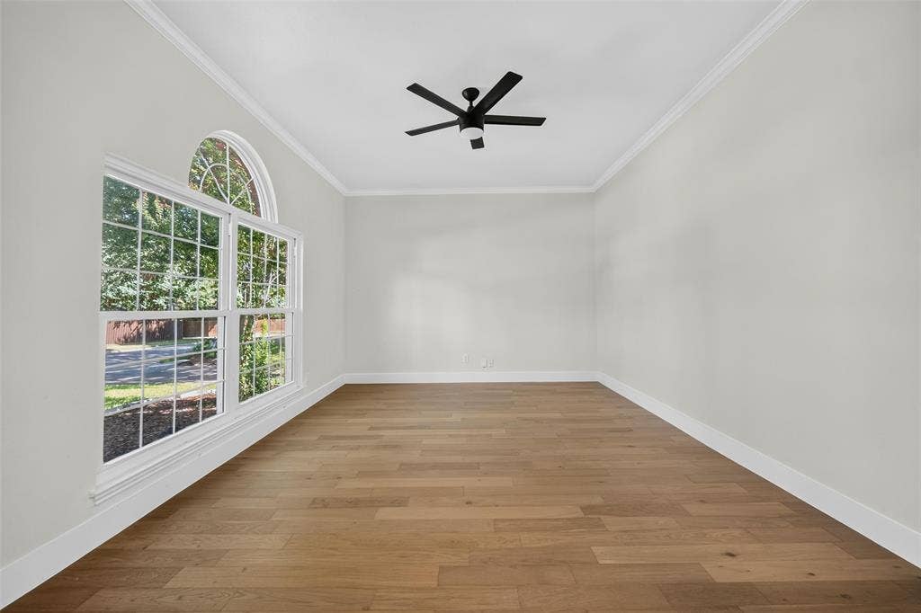 3041 Hillingdon Drive, Richardson, TX 75082 Wood-finish flooring, crown molding, and a modern ceiling fan