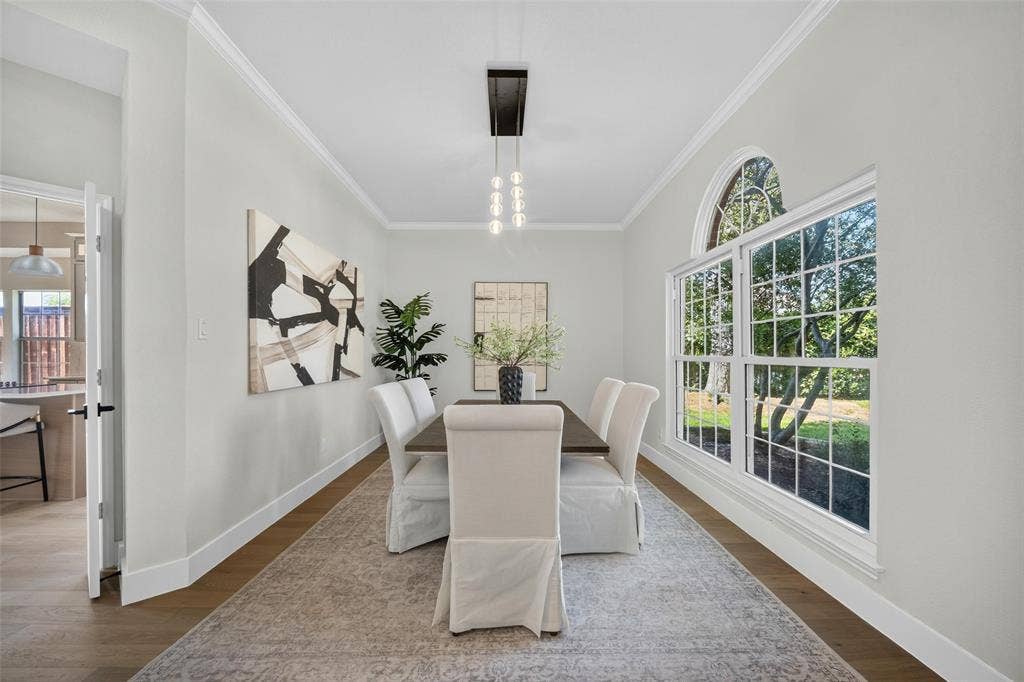 3041 Hillingdon Drive, Richardson, TX 75082 Wood-finish flooring, crown molding, and a chandelier with glass globes