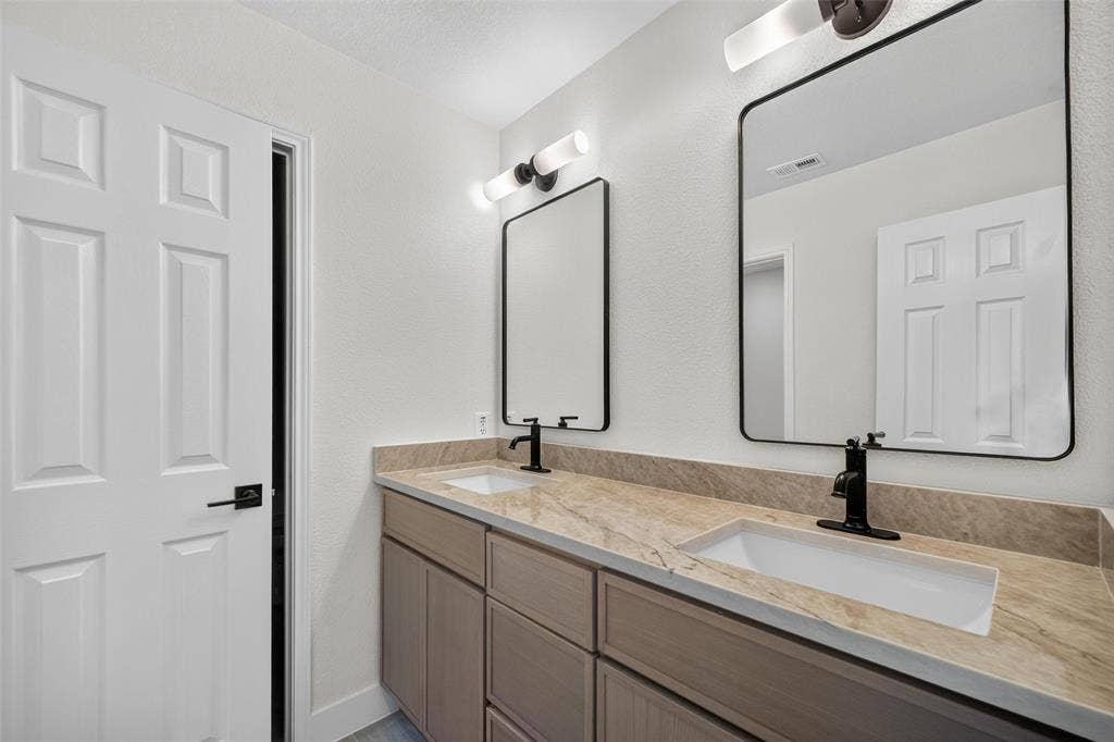3041 Hillingdon Drive, Richardson, TX 75082 Dual rectangular vessel sinks with matte black faucets, set into a stone-finish countertop