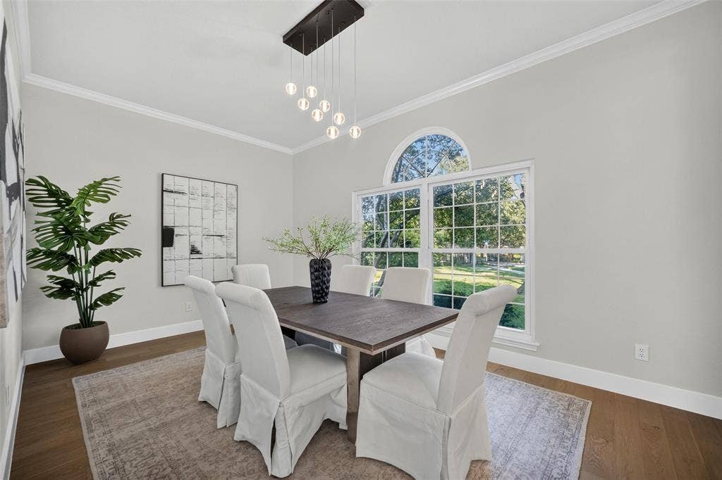 3041 Hillingdon Drive, Richardson, TX 75082 Wood-finish flooring, crown molding, and a contemporary chandelier