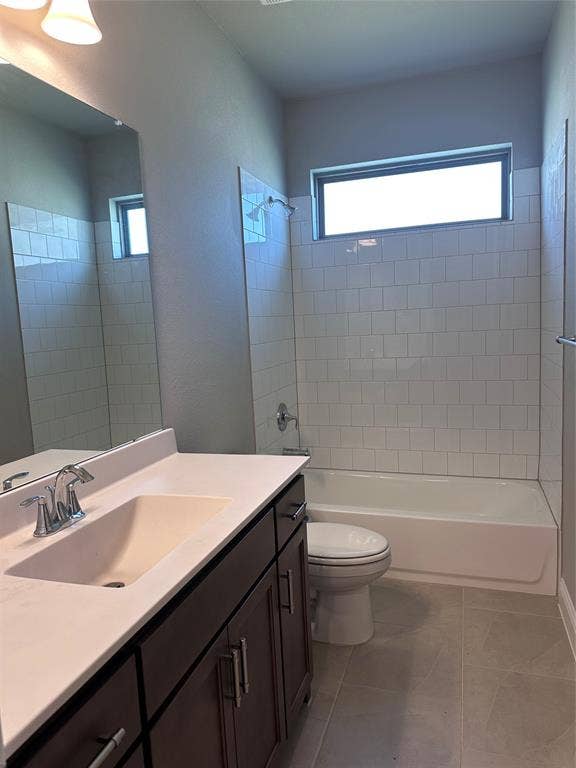 2608 Roaming Trail, Northlake, TX 76247 Bathroom featuring a single vanity with dark wood-finish cabinetry, a single basin sink, a bathtub with subway tile surround, and an integrated window