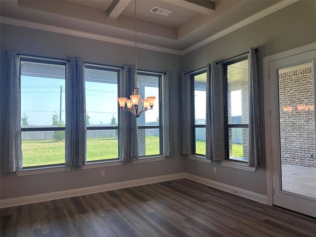 2608 Roaming Trail, Northlake, TX 76247 Tray ceiling with crown molding, wood-finish flooring, multiple windows, and a glass-paneled door