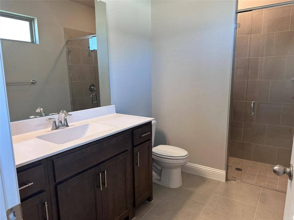 2608 Roaming Trail, Northlake, TX 76247 Bathroom with dark wood-finish vanity, integrated sink, and chrome fixtures