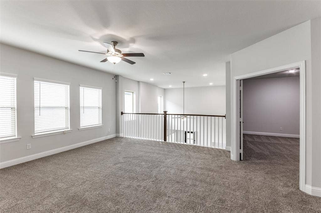 Carpeted spare room with a ceiling fan, baseboards, and recessed lighting