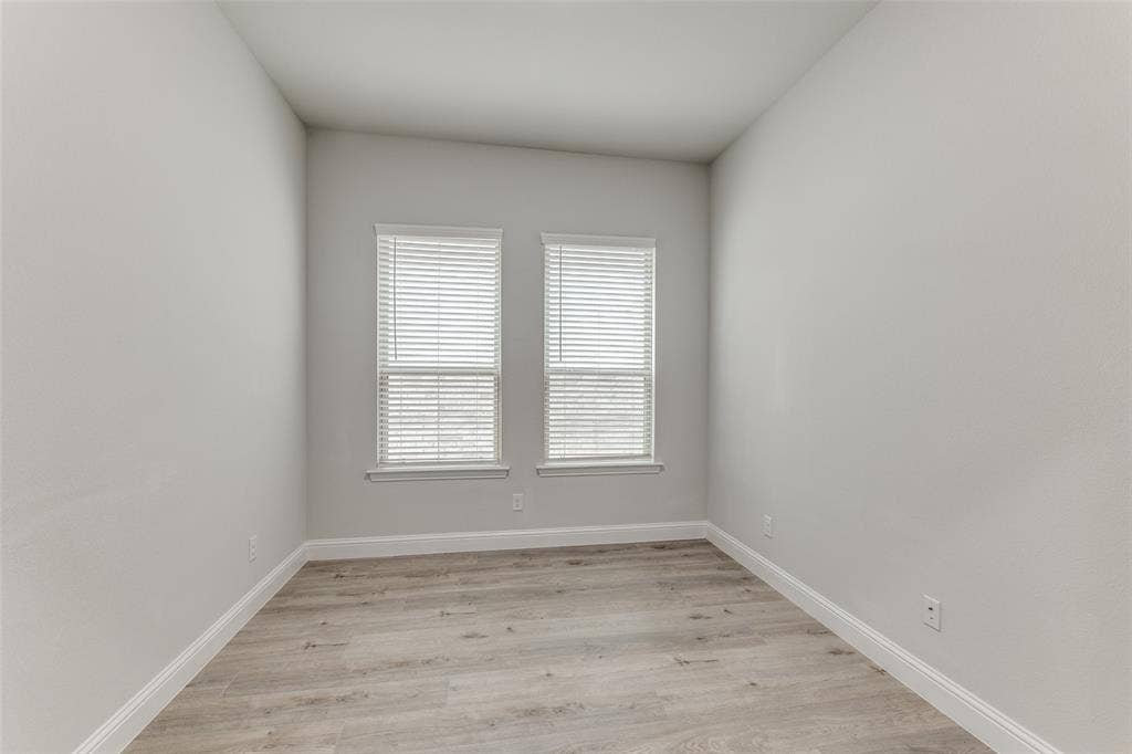 Spare room with light wood-type flooring and baseboards