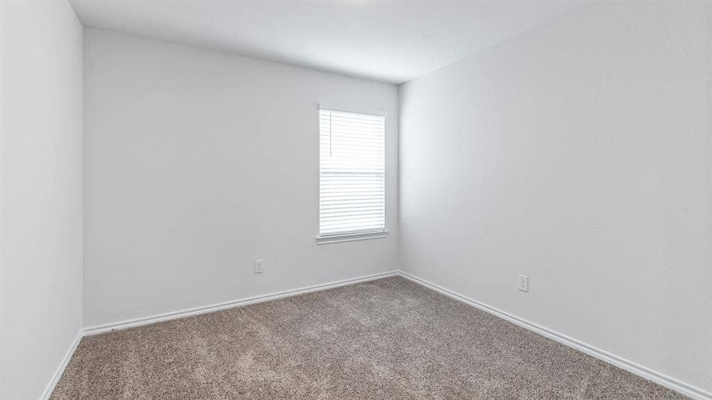 4028 Ripplewood Drive, Lindale, TX 75771 Neutral wall tones, gray carpeting, and a single window with blinds