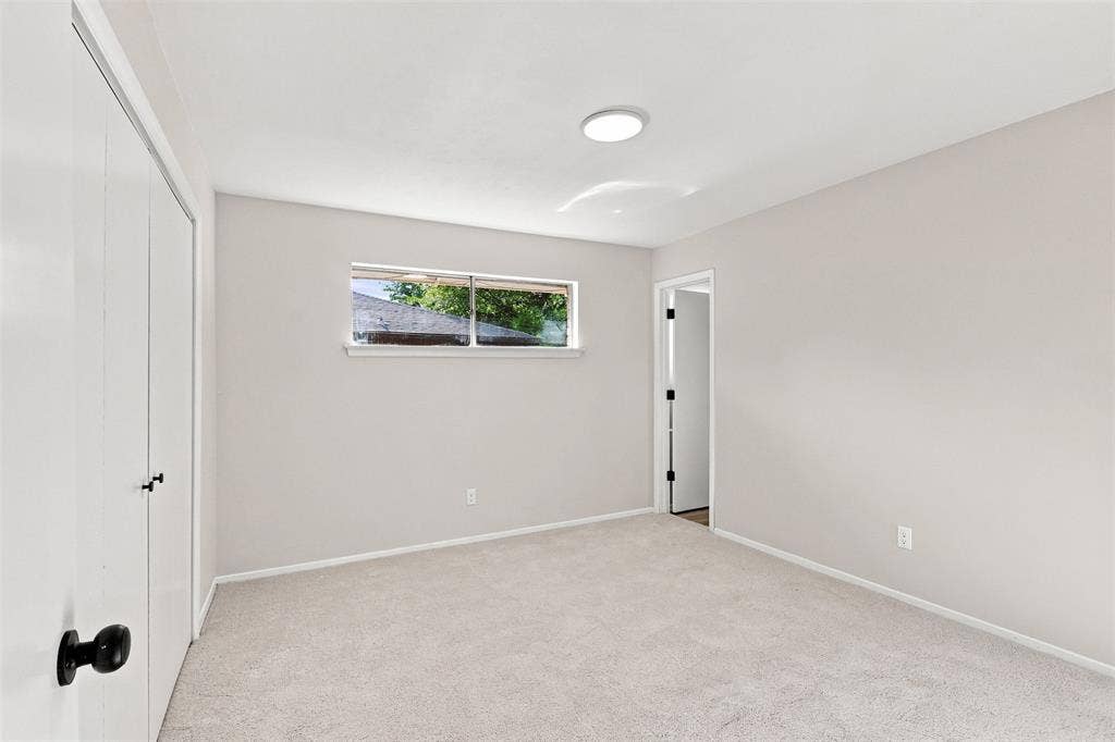 Neutral-toned walls complement the light-colored carpeting