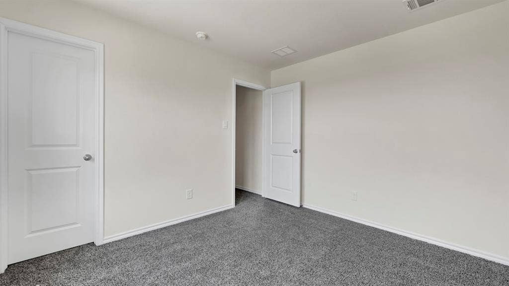 3058 Hidden Valley Drive, Lindale, TX 75771 Gray carpeted flooring with white baseboards, light-toned walls, and white paneled doors