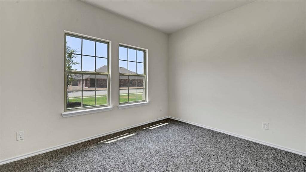 3058 Hidden Valley Drive, Lindale, TX 75771 Dual pane windows, white wall finishes, and dark gray carpeting