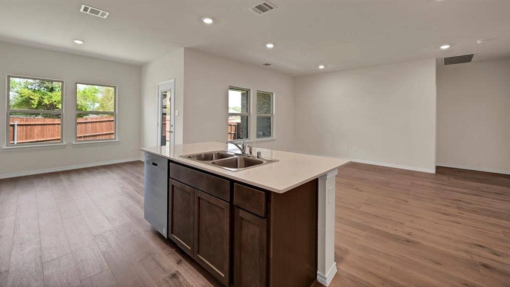3058 Hidden Valley Drive, Lindale, TX 75771 Kitchen island with a double basin sink and a built-in dishwasher