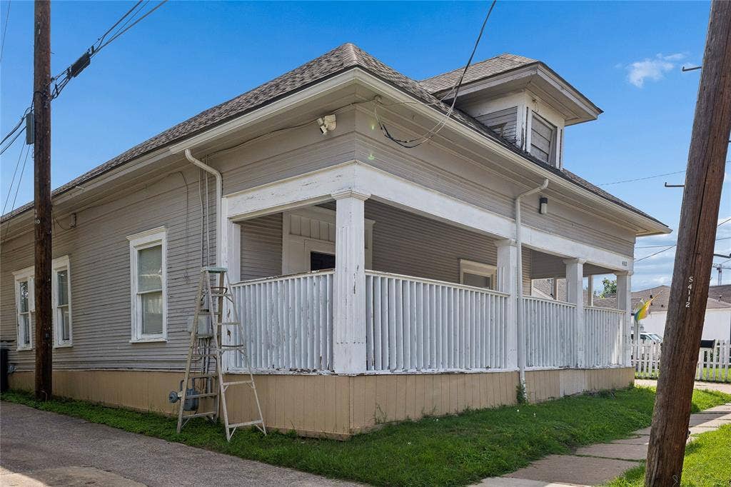 4112 Congress Avenue, Dallas, TX 75219 Exterior featuring a wraparound porch with white columns and railings, gray siding, and a gabled roof