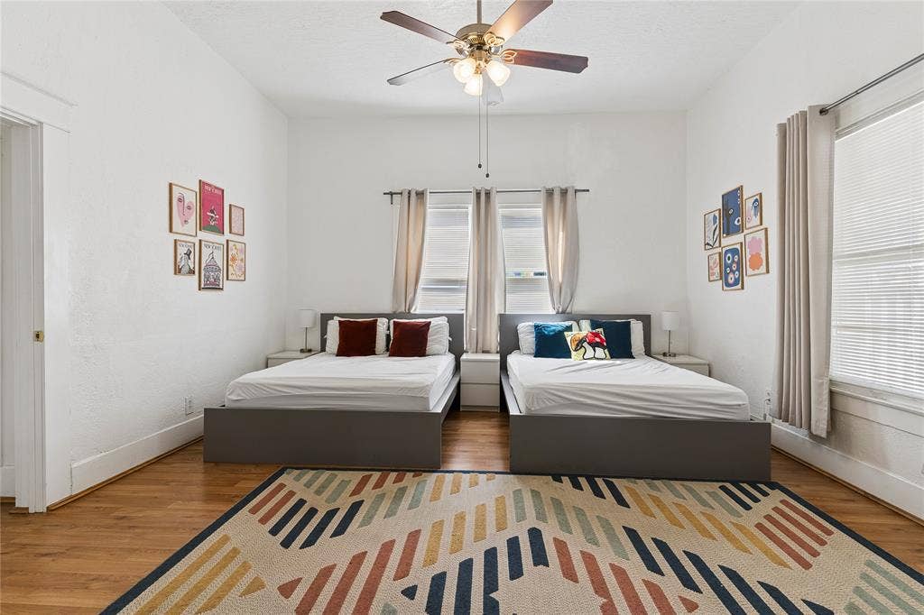 4112 Congress Avenue, Dallas, TX 75219 Hardwood-style flooring, white painted walls, and a ceiling fan with integrated lighting