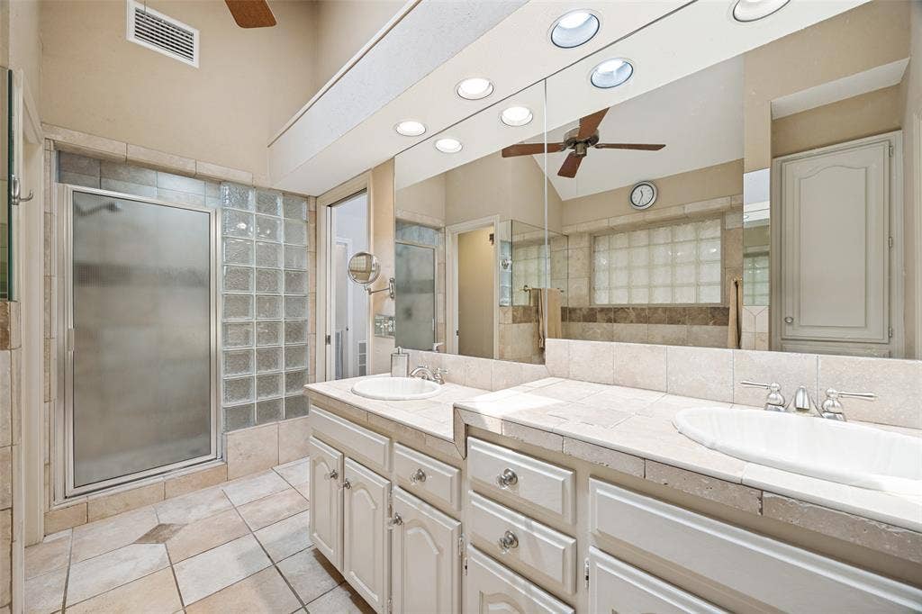 6223 Fox Trail, Dallas, TX 75248 Lots of storage, dual height individual vanities and stand alone shower in the primary bath