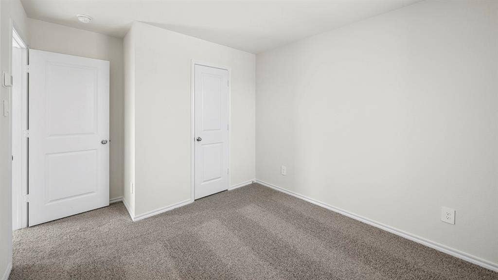 5028 Shumard Drive, Lindale, TX 75771 Neutral wall color, two-panel interior doors, and gray carpet