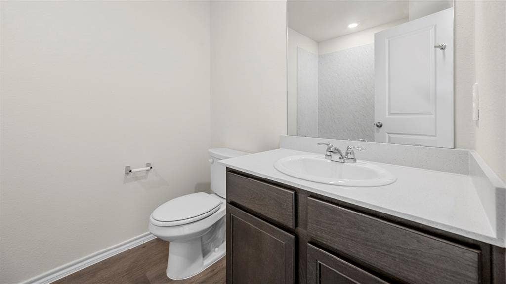 5028 Shumard Drive, Lindale, TX 75771 White vanity with an integrated basin sink, chrome faucet, and dark wood-finish cabinetry