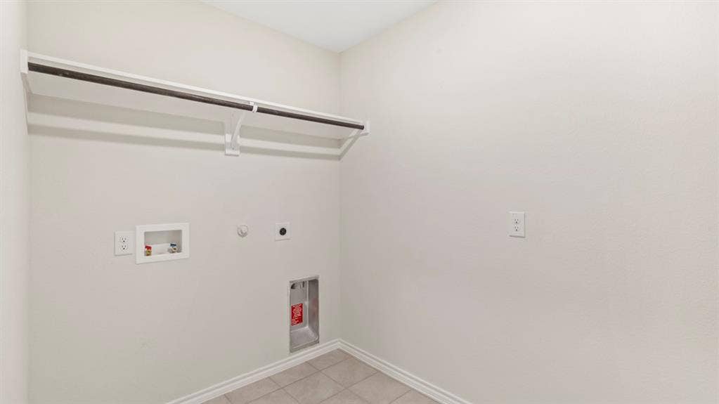 3037 Hidden Valley Drive, Lindale, TX 75771 Wall-mounted shelving with a hanging rod, utility hookups, and tiled flooring