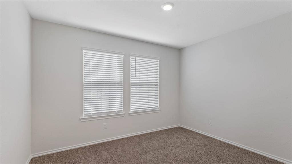 3037 Hidden Valley Drive, Lindale, TX 75771 Neutral-toned walls complement plush carpeting