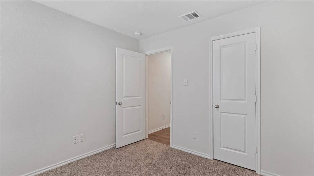 3037 Hidden Valley Drive, Lindale, TX 75771 Light gray walls with white trim, gray carpeting, and white two-panel doors