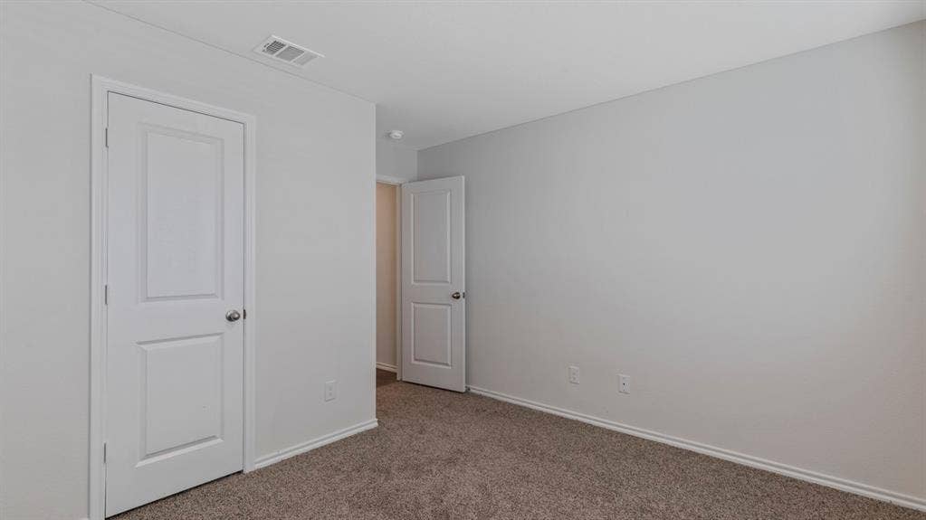 3037 Hidden Valley Drive, Lindale, TX 75771 Light neutral wall paint, white trim, and neutral carpeting