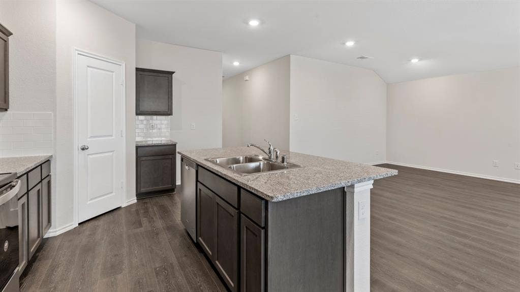 3037 Hidden Valley Drive, Lindale, TX 75771 Kitchen island with a double basin sink and a stone-finish countertop